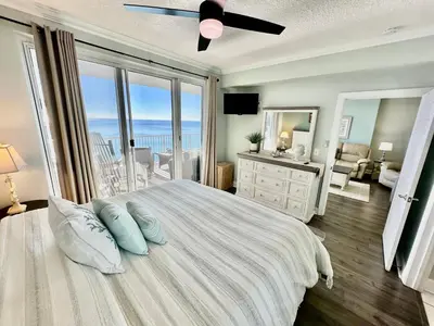 a bedroom with a bed with a view of the ocean at Ocean Reef 1705 in Panama City Beach