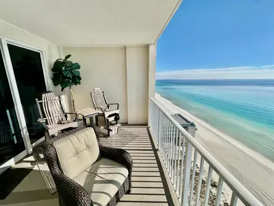 a balcony with a couch and chairs on the beach at Ocean Reef 1705 in Panama City Beach