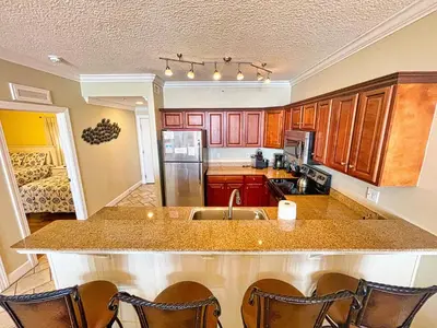 a kitchen with a sink and a counter top at Tropic Winds 1706 in Panama City Beach