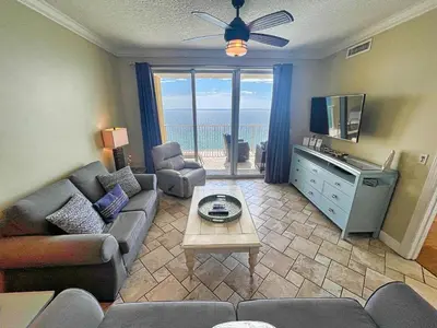 a living room with a couch and a tv at Tropic Winds 1706 in Panama City Beach