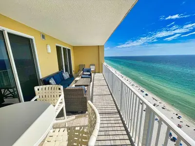 a balcony with chairs and a view of the ocean at Tropic Winds 1706 in Panama City Beach