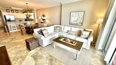 a living room with a couch and a table at Tropic Winds 1606 in Panama City Beach