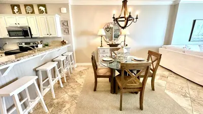 a kitchen and dining room with a table and chairs at Tropic Winds 1606 in Panama City Beach