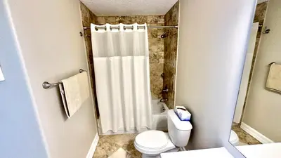 a bathroom with a shower curtain and a toilet at Tropic Winds 1606 in Panama City Beach