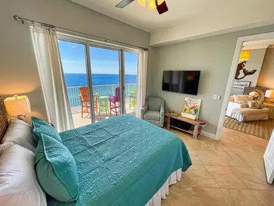 a bedroom with a bed and a view of the ocean at Ocean Reef 1903 in Panama City Beach