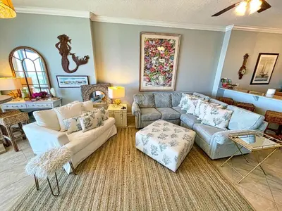 a living room with two couches and a table at Ocean Reef 1903 in Panama City Beach