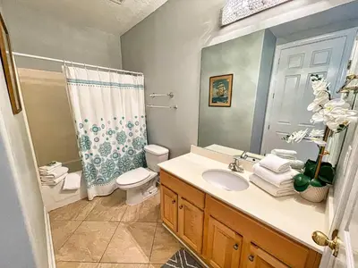 a bathroom with a sink and a toilet and a shower at Ocean Reef 1903 in Panama City Beach