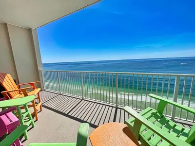 a balcony with chairs and a view of the ocean at Ocean Reef 1903 in Panama City Beach