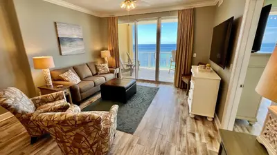 a living room with a couch and a television at Tropic Winds 904 in Panama City Beach
