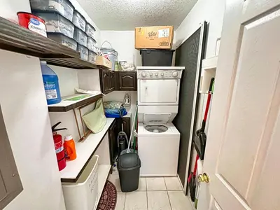 a small kitchen with a washing machine and a washer at Ocean Reef 2105 in Panama City Beach