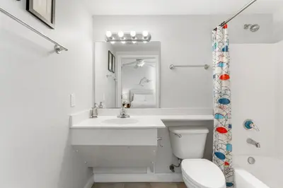 a white bathroom with a sink and a toilet at Shores Of Panama #2101 in Panama City Beach