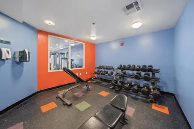 a gym with cardio equipment and chairs in a room at Shores Of Panama #2101 in Panama City Beach