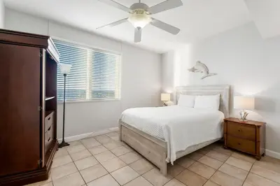 a bedroom with a bed and a ceiling fan at Shores Of Panama #2101 in Panama City Beach