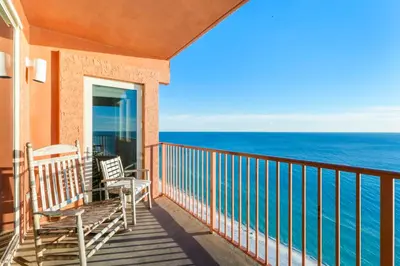 a balcony with two chairs and the ocean at Shores Of Panama #2101 in Panama City Beach