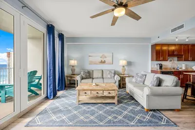 a living room with a couch and a table at Laketown Wharf #1517 by Nautical Properties in Panama City Beach