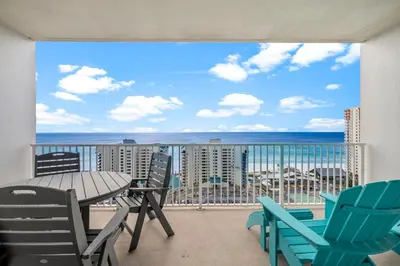 a balcony with a table and chairs and a view of the ocean at Laketown Wharf #1517 by Nautical Properties in Panama City Beach