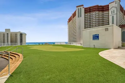 a golf course with a green field and buildings at Laketown Wharf #1022 in Panama City Beach