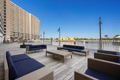 a patio with couches and tables on a building at Laketown Wharf #1022 in Panama City Beach