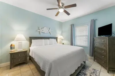 a bedroom with a bed and a flat screen tv at Laketown Wharf #1022 in Panama City Beach
