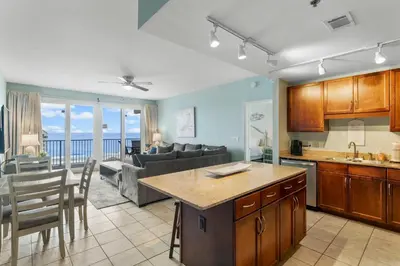 a kitchen and living room with a view of the ocean at Laketown Wharf #1022 in Panama City Beach