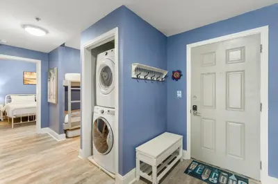 a blue laundry room with a washer and dryer at Laketown Wharf #0606 in Panama City Beach