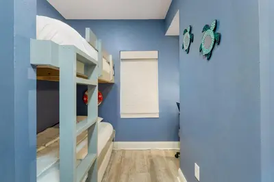 a bunk bed room with a blue wall at Laketown Wharf #0606 in Panama City Beach