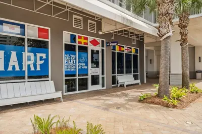 a large building with two benches in front of it at Laketown Wharf #0702 in Panama City Beach