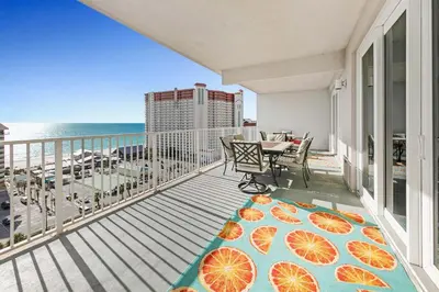 a balcony with a table and a view of the ocean at Laketown Wharf 1120 by Emerald Coast Retreats in Panama City Beach