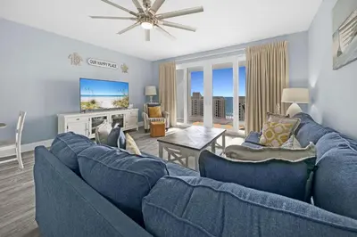 a living room with a blue couch and a table at Laketown Wharf 1120 by Emerald Coast Retreats in Panama City Beach