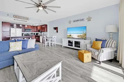 a living room with a blue couch and a table at Laketown Wharf 1120 by Emerald Coast Retreats in Panama City Beach