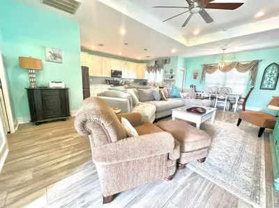 a living room with a couch and a table at 2 Fins Up, Beach Home, Private Pool , Golf Cart, 6 beds in Panama City Beach