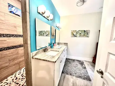a bathroom with a sink and a mirror at 2 Fins Up, Beach Home, Private Pool , Golf Cart, 6 beds in Panama City Beach