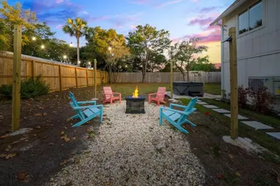 a group of chairs sitting around a fire in a yard at Nest & Nook, Hot Tub, Fire pit, Deck, Yard, close to lake in Panama City Beach