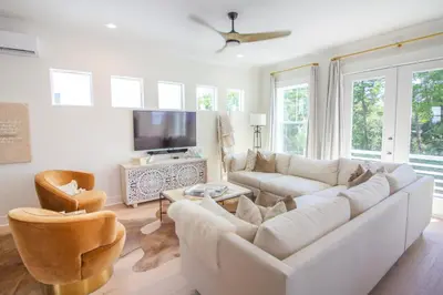 a living room with a white couch and a tv at POOL | Heart & Soul Luxury | Walk to Beach in Inlet Beach