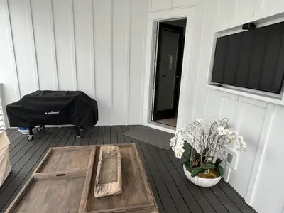 a room with a table and a flat screen tv at POOL | Heart & Soul Luxury | Walk to Beach in Inlet Beach