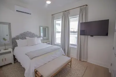 a bedroom with a bed and a large window at POOL | Heart & Soul Luxury | Walk to Beach in Inlet Beach