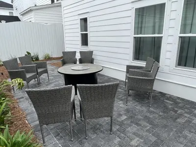 a patio with chairs and a table and a table and chairs at POOL | Heart & Soul Luxury | Walk to Beach in Inlet Beach