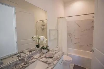 a white bathroom with a sink and a toilet at POOL | Heart & Soul Luxury | Walk to Beach in Inlet Beach