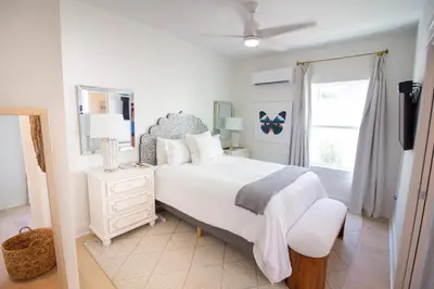 a white bedroom with a bed and a window at POOL | Heart & Soul Luxury | Walk to Beach in Inlet Beach
