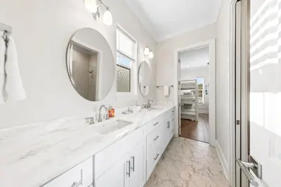 a white bathroom with a sink and a mirror at Walk to Beach! Sleeps 18 - 10 beds in Rosemary Beach