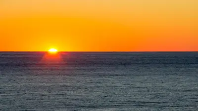 an orange and yellow sunset over the ocean at Beach Haven! 2BR 2BA Sleeps 6! Coastal paradise awaits! in Panama City Beach