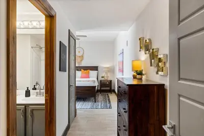 a hallway with a bedroom with a bed and a sink at 707 Sterling Reef in Panama City Beach