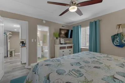 a bedroom with a bed and a ceiling fan at Sugar Beach C1 in Panama City Beach