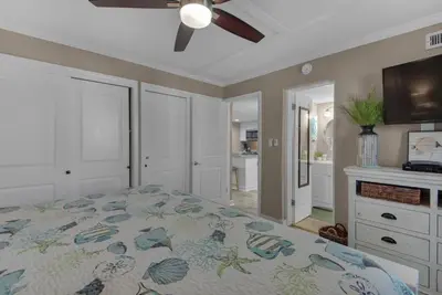a bedroom with a bed and a ceiling fan at Sugar Beach C1 in Panama City Beach
