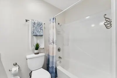 a white bathroom with a toilet and a shower at 9614 Beach Blvd in Panama City Beach