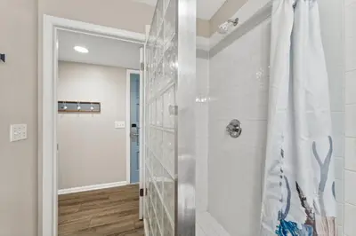 a shower with a glass door in a bathroom at 9614 Beach Blvd in Panama City Beach