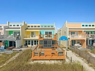 a row of houses on the beach in front at 9614 Beach Blvd in Panama City Beach