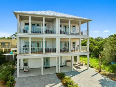 an aerial view of a white house with balconies at Grand Retreat I! 4BR 5BA Sleeps 15! Private Pool! Luxury and comfort await! in Panama City Beach