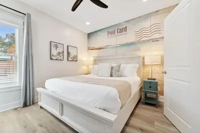 a white bedroom with a bed and a window at Grand Retreat II: 4BR, 5BA, sleeps 15 Private pool Your perfect escape! in Panama City Beach