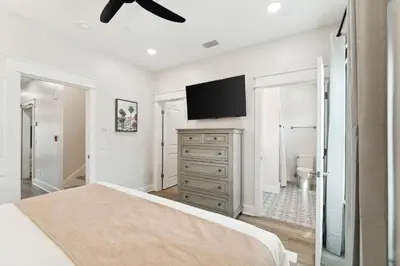 a bedroom with a bed and a flat screen tv at Grand Retreat II: 4BR, 5BA, sleeps 15 Private pool Your perfect escape! in Panama City Beach